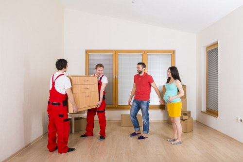 Local removals team handling furniture in a Bermondsey apartment building