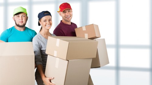 Team member carrying furniture carefully through a property