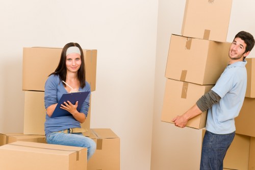 Moving crew handling apartment access in Bermondsey with furniture and boxes